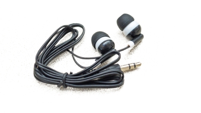 Black earbuds with white trim coiled up. 