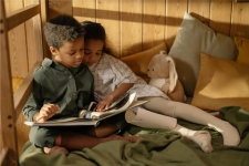 TeachingBooks for Libraries showing two siblings, a boy and a girl, looking into a book together