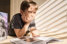 Britannica School - Elementary resource image showing a young boy looking through a book