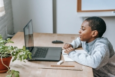 PBS Wisconsin Education resource image showing a young boy at a desk looking at a laptop screen