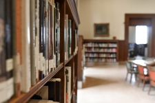 EBSCOHost Research Databases resource image showing a library room with books on shelves