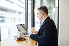 Gale Courses; Business resource image showing an older man in a business suit on a laptop