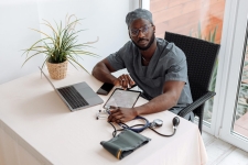 Gale Courses; Healthcare and Medical resource image showing man at a desk in doctor scrubs