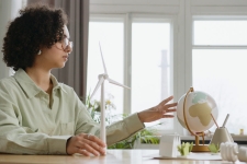 GreenFILE resource image showing woman looking at a small globe