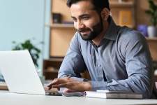 MasterFILE Complete resource image showing an adult male smiling while looking at a laptop screen