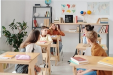 Middle Search Plus resource image depicting a middle school classroom with six students mid-discussion with each other