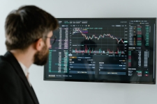 Regional Business News resource image showing a man looking at stock charts on a monitor