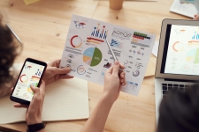 Reference Solutions resource image showing two people looking at a sheet of charts