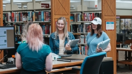 2nd Floor Reference Desk helping patrons