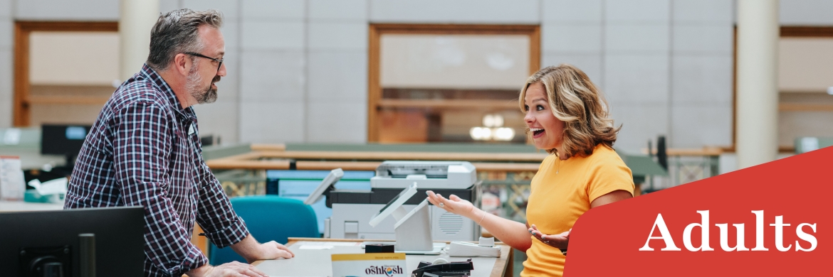 Librarian and patron at desk talking